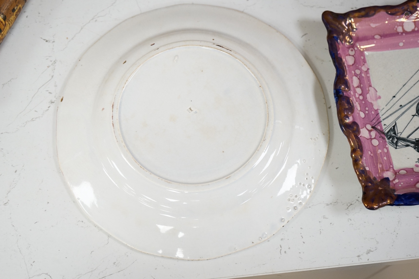 A 19th century Sunderland pink lustre ‘ship’ plaque and an HMS, Duke of Wellington plate, largest 24cm in diameter